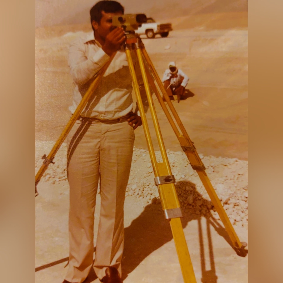Late young Muhammad Khalid, using a surveyor's tripod, conducting ground work in the blistering heat of Sharurah, Saudi Arabia.